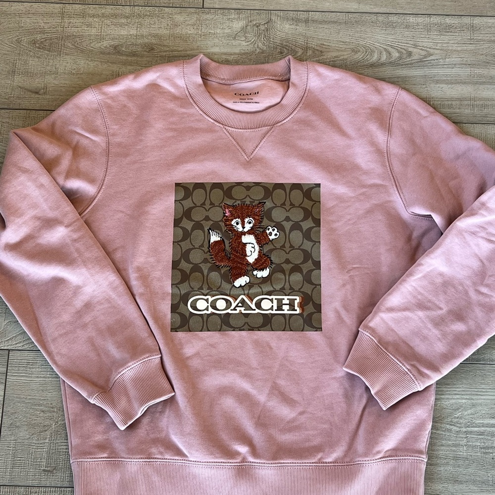 - Coach Pink Crewneck Sweater with Graphic Design